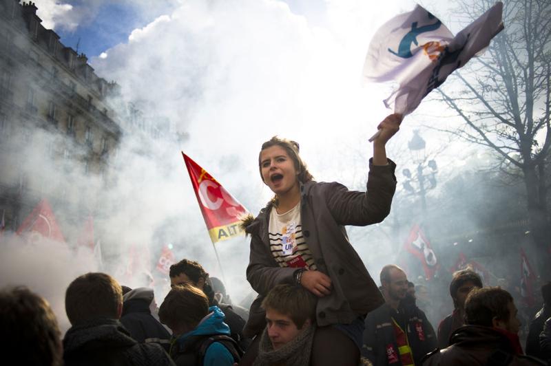 A high school student waves a flag during a demonstration on October 20, 2010, in front of the French Senate in Paris, to protest governemental pensions reform.